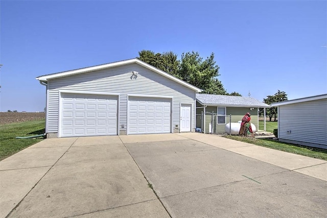 view of front of property featuring an outdoor structure and a garage