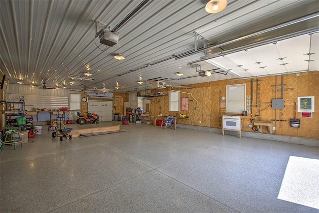 garage with a workshop area and a garage door opener