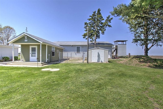 9010 School Rd, Argenta, IL 62501 - exterior space featuring fence, a storage unit, and an outbuilding