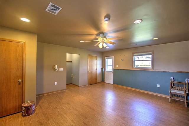 interior space featuring a ceiling fan, visible vents, wood finished floors, baseboards, and recessed lighting