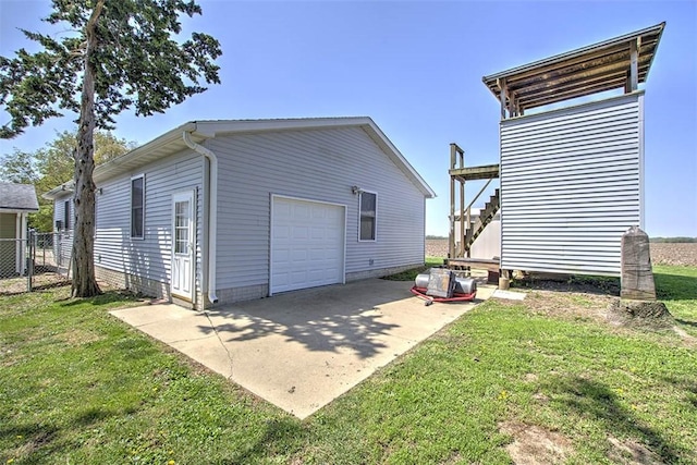 9010 School Rd, Argenta, IL 62501 - view of home's exterior with a lawn, fence, concrete driveway, and a detached garage