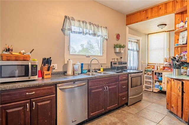 101 W N Water St, Bethany, IL 61914 - kitchen featuring light tile patterned floors, dark countertops, stainless steel appliances, and a sink