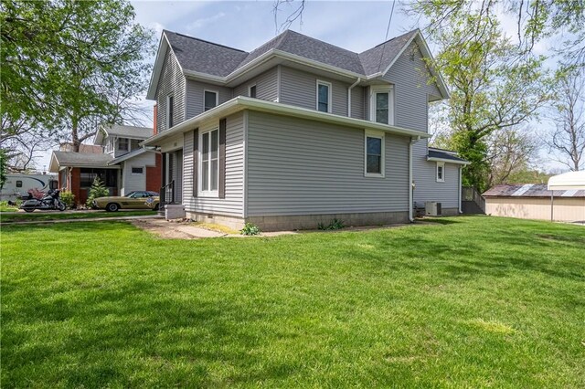 101 W N Water St, Bethany, IL 61914 - view of property exterior featuring roof with shingles and a yard