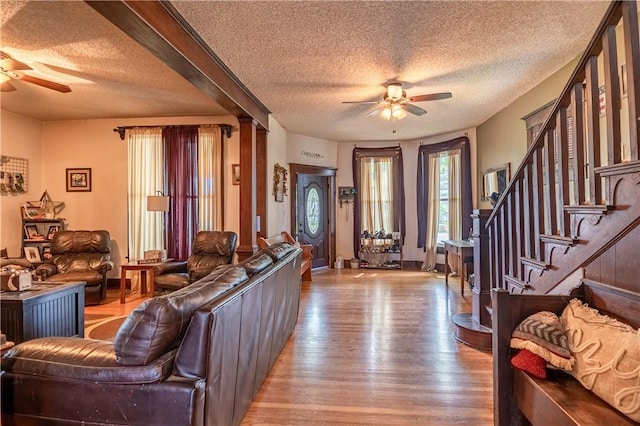 101 W N Water St, Bethany, IL 61914 - living area featuring a textured ceiling, baseboards, a ceiling fan, wood finished floors, and stairway