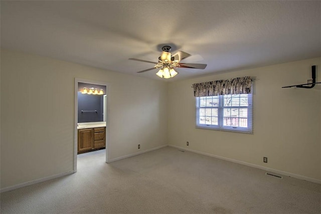 unfurnished room with light carpet, ceiling fan, visible vents, and baseboards