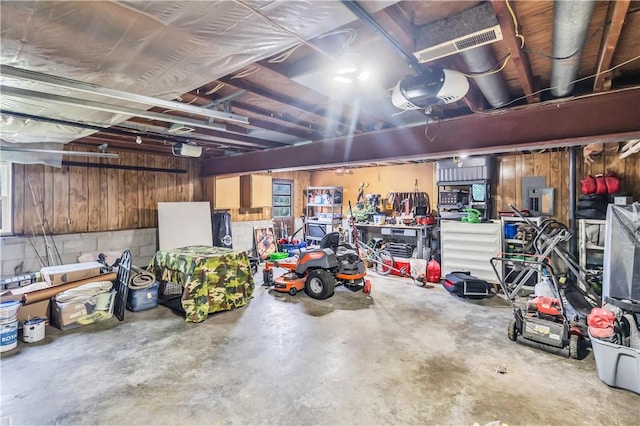 1450 W Westside Dr, Mt Zion, IL 62549 - garage featuring a garage door opener and wood walls