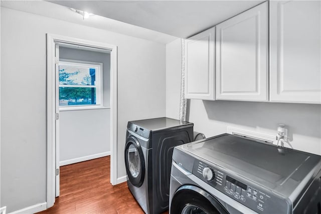 1450 W Westside Dr, Mt Zion, IL 62549 - laundry room featuring washer and dryer, cabinet space, dark wood-style floors, and baseboards