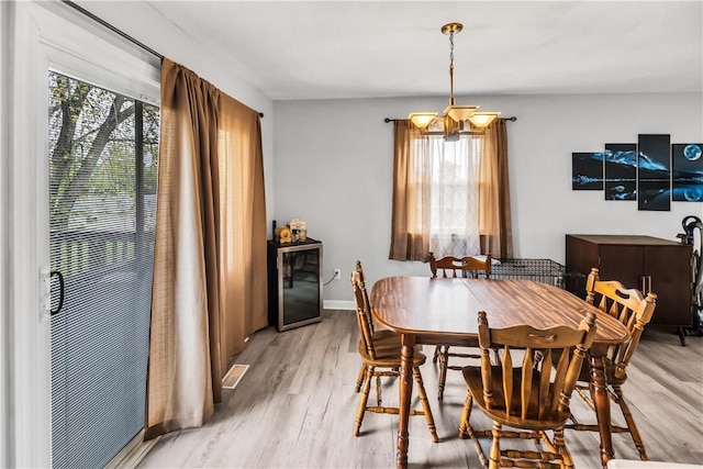 1450 W Westside Dr, Mt Zion, IL 62549 - dining room featuring healthy amount of natural light, light wood-style flooring, a chandelier, and baseboards