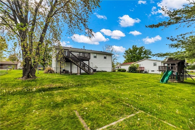 1450 W Westside Dr, Mt Zion, IL 62549 - view of green lawn featuring a playground, stairway, and a deck