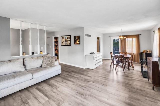 1450 W Westside Dr, Mt Zion, IL 62549 - living area with baseboards, wood finished floors, and a chandelier