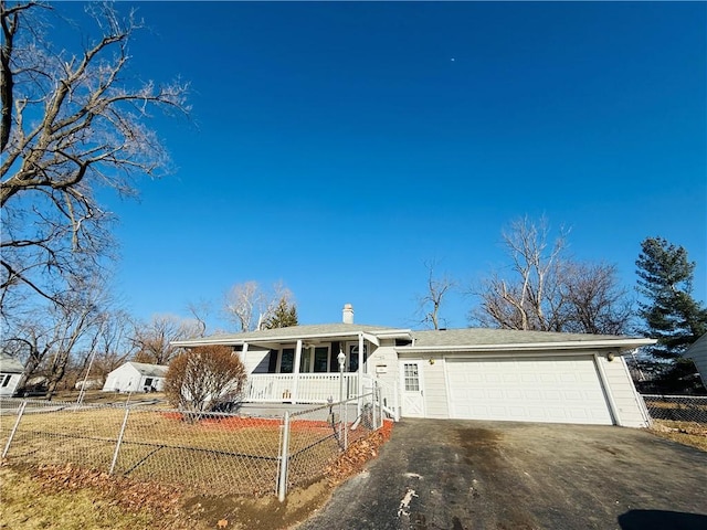 single story home featuring aphalt driveway, a chimney, a porch, an attached garage, and fence