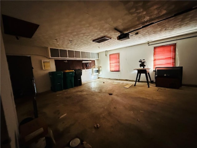 interior space with a garage and a textured ceiling