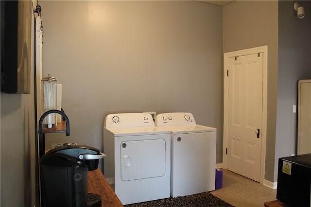 washroom featuring washing machine and dryer and light colored carpet