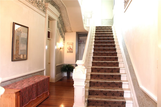 stairs featuring hardwood / wood-style flooring