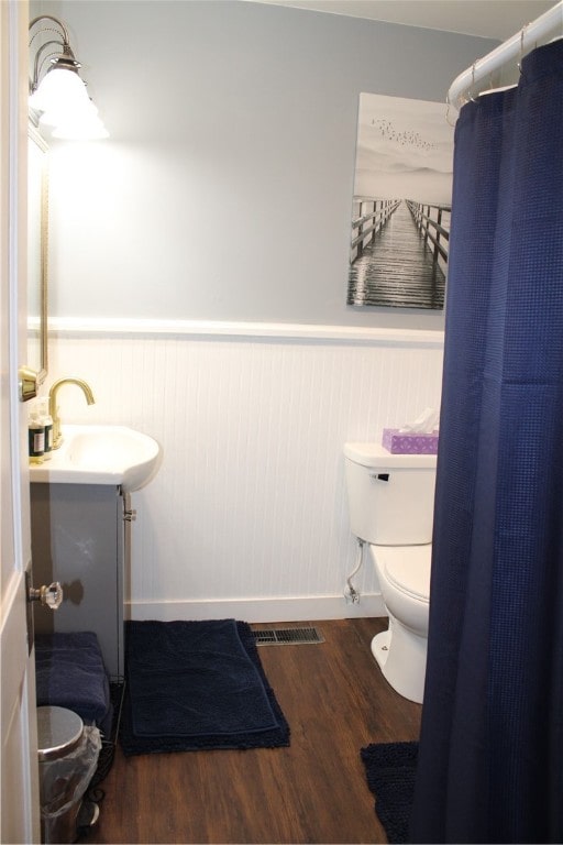 bathroom with hardwood / wood-style floors, vanity, and toilet