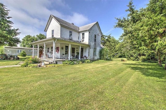 59 Lynn St, Weldon, IL 61882 - country-style home featuring covered porch and a front lawn