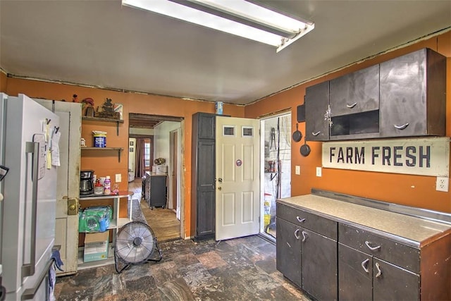 59 Lynn St, Weldon, IL 61882 - kitchen featuring freestanding refrigerator, dark brown cabinets, and light countertops
