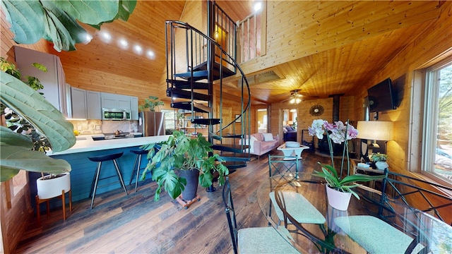 202 Eagle Blf, Oakwood, IL 61858 - dining space with plenty of natural light, stairway, wood walls, wooden ceiling, and wood finished floors