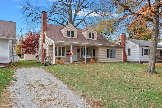 cape cod-style house with covered porch and a front yard