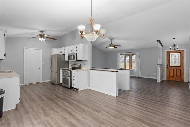kitchen with ceiling fan with notable chandelier, stainless steel appliances, baseboards, white cabinets, and dark wood finished floors