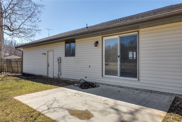 back of house featuring a lawn, fence, and a patio area