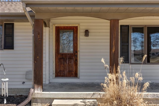 view of exterior entry with covered porch
