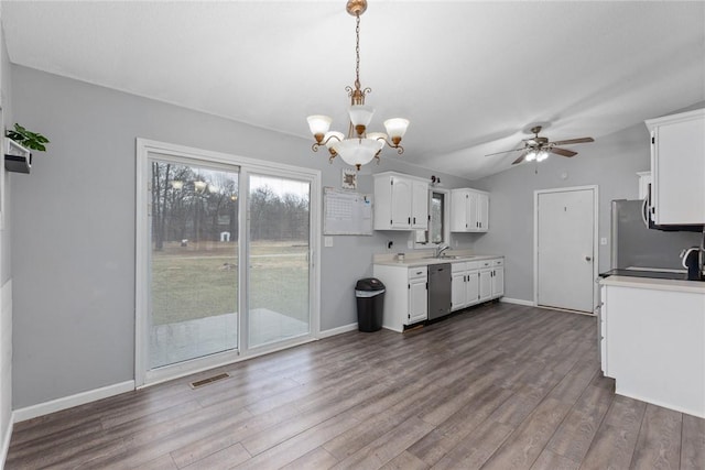 kitchen with fridge, light countertops, dishwasher, white cabinetry, and visible vents