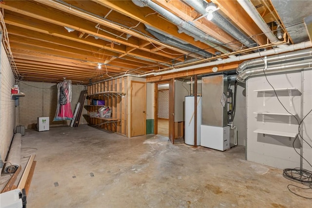 unfinished below grade area featuring water heater and heating unit