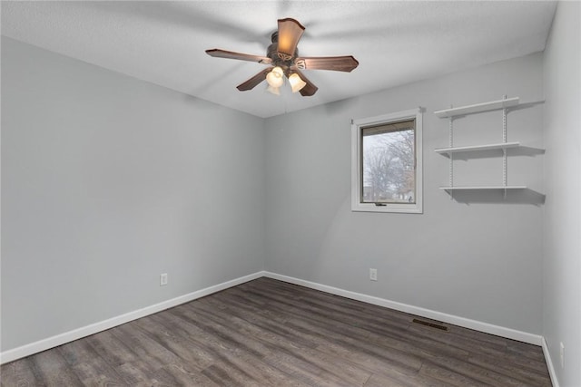 unfurnished room with baseboards, visible vents, wood finished floors, and a ceiling fan