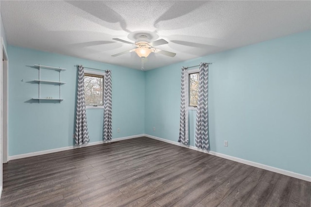 unfurnished room featuring wood finished floors, a wealth of natural light, a textured ceiling, and ceiling fan