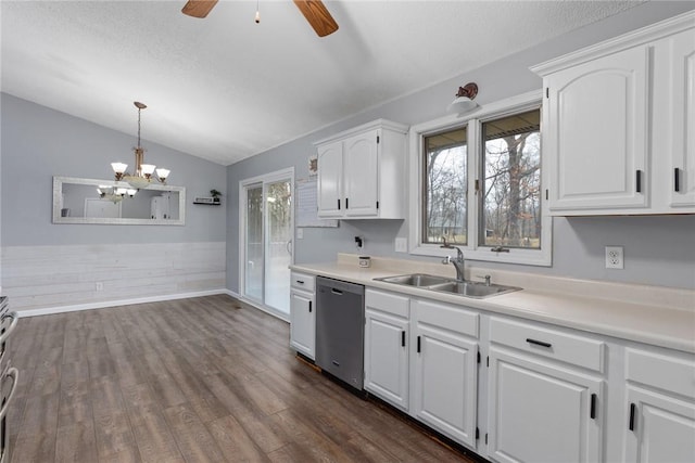kitchen featuring light countertops, dishwasher, a sink, white cabinetry, and lofted ceiling