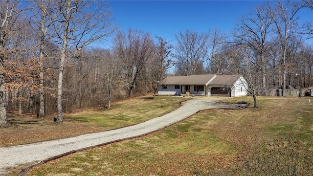 view of front of home featuring fence, aphalt driveway, a front yard, and an attached carport