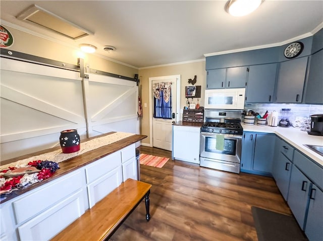 421 S 8th St, Marshall, IL 62441 - kitchen with white microwave, gas stove, ornamental molding, blue cabinetry, and dark wood-style flooring