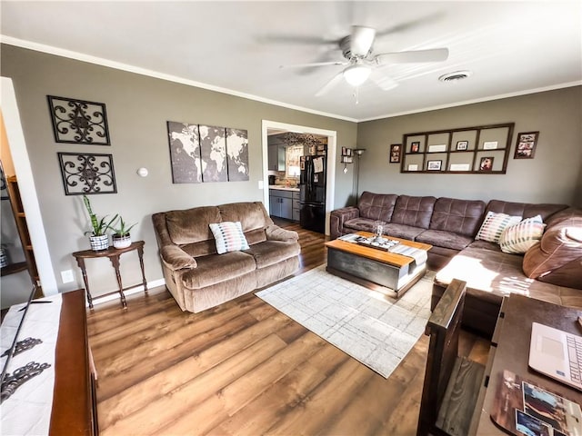421 S 8th St, Marshall, IL 62441 - living room with wood finished floors, a ceiling fan, and crown molding