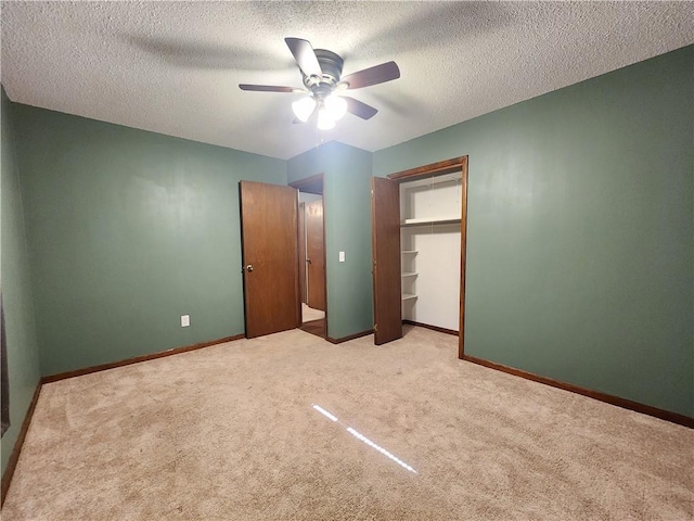 324 Madison St, Mason, IL 62443 - unfurnished bedroom with light carpet, a textured ceiling, a ceiling fan, and a closet