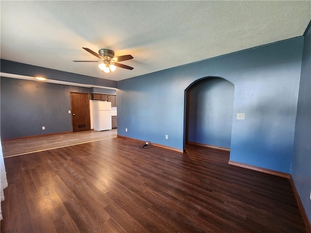 324 Madison St, Mason, IL 62443 - unfurnished room with arched walkways, a ceiling fan, wood finished floors, and a textured ceiling