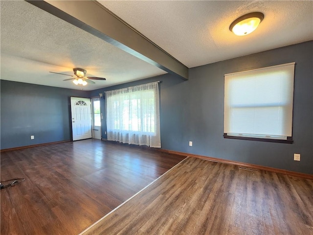 324 Madison St, Mason, IL 62443 - empty room featuring a textured ceiling, wood finished floors, and a ceiling fan