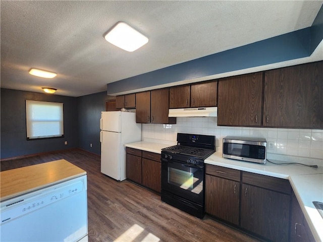 324 Madison St, Mason, IL 62443 - kitchen with white appliances, under cabinet range hood, dark brown cabinetry, light countertops, and a textured ceiling