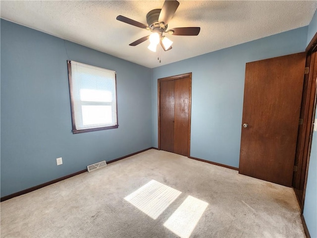 324 Madison St, Mason, IL 62443 - unfurnished bedroom featuring a closet, carpet floors, a textured ceiling, and ceiling fan