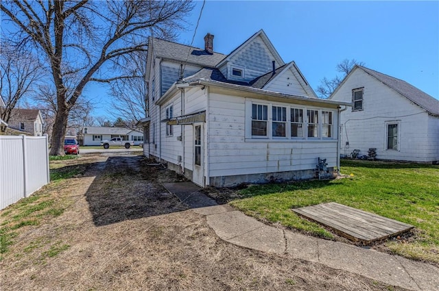 109 S Saint John St, Assumption, IL 62510 - back of property with a lawn, fence, and a chimney