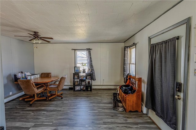 109 S Saint John St, Assumption, IL 62510 - dining area with baseboard heating, a baseboard heating unit, a ceiling fan, and wood finished floors