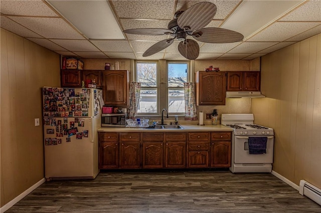 109 S Saint John St, Assumption, IL 62510 - kitchen featuring a sink, under cabinet range hood, light countertops, white appliances, and a baseboard radiator