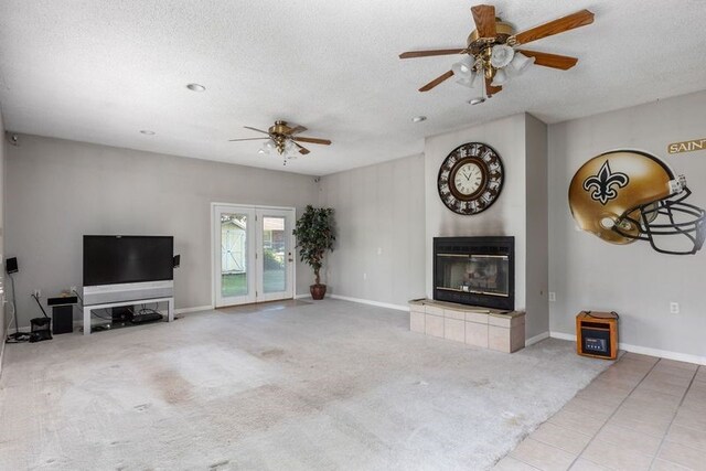 801 N Parkview St, Effingham, IL 62401 - unfurnished living room with ceiling fan, a tiled fireplace, a textured ceiling, carpet flooring, and baseboards