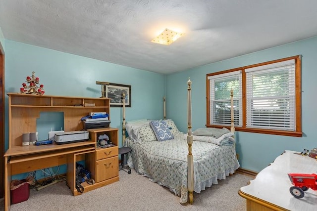 bedroom featuring carpet flooring and a textured ceiling