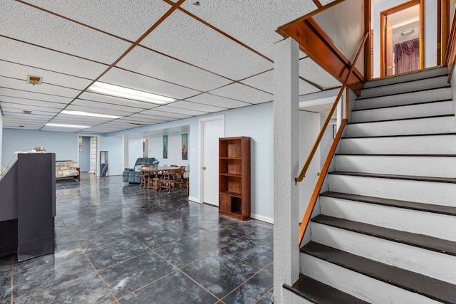 stairs featuring a paneled ceiling