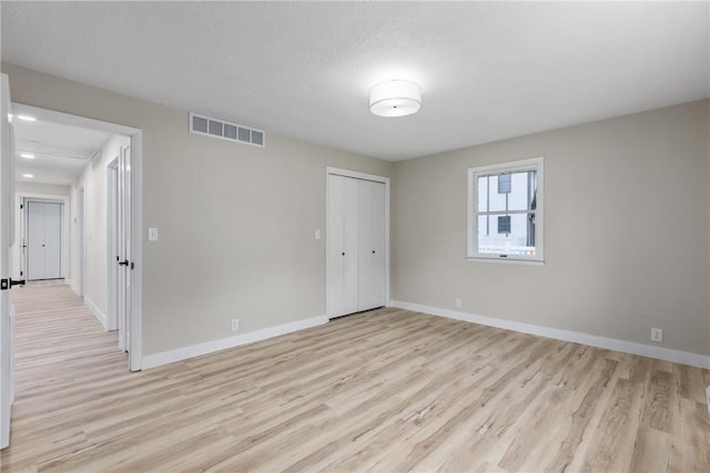unfurnished room with light wood-style flooring and baseboards