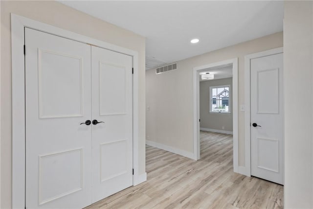 hall featuring recessed lighting, baseboards, and light wood-style flooring