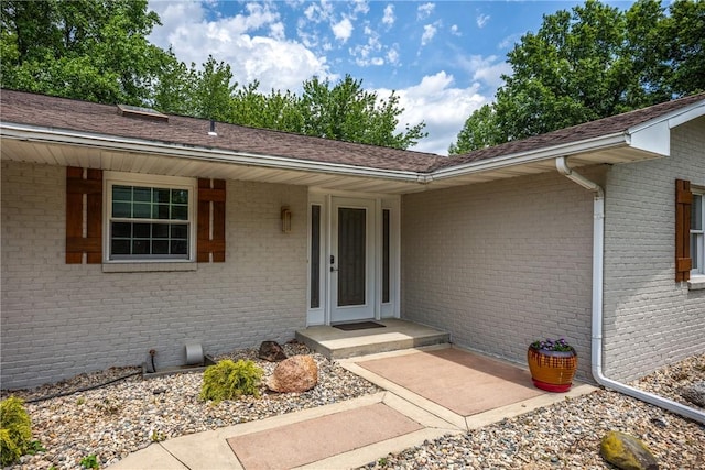 property entrance featuring brick siding