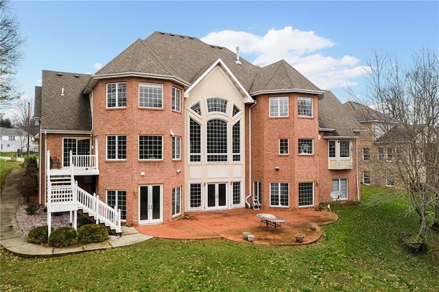 rear view of property featuring a lawn and a patio area