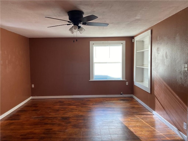 605 W Reynolds St, Newton, IL 62448 - empty room featuring wood finished floors, built in features, and a ceiling fan